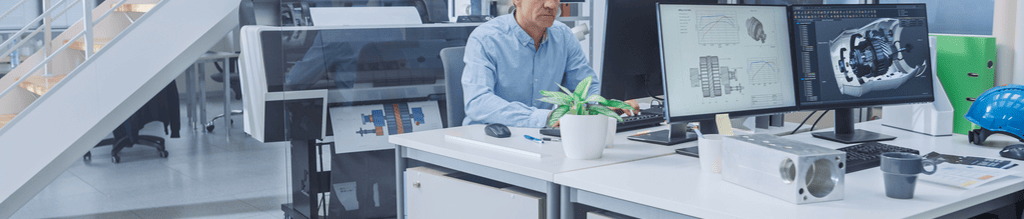 Person sitting in office with PC, telephone and printer